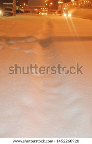 Evening snow, frost, lamps illuminate the snow. Royalty-Free Stock Photo #1452268928