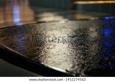 The street reflections on the wet floor in the modern city at rainy night