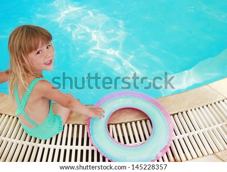 a beautiful little girl in the water pool