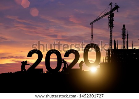 Silhouette staff works as a team to prepare to welcome the new year 2020 Royalty-Free Stock Photo #1452301727