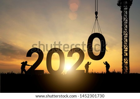 Silhouette staff works as a team to prepare to welcome the new year 2020 Royalty-Free Stock Photo #1452301730