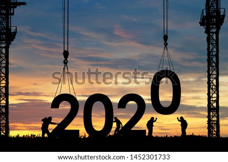 Silhouette staff works as a team to prepare to welcome the new year 2020 Royalty-Free Stock Photo #1452301733