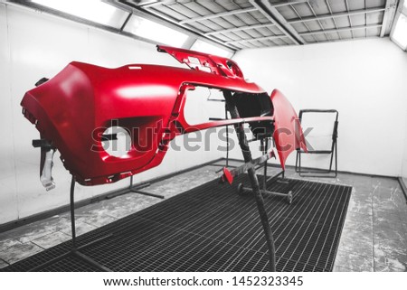 Car element body after painting. Drying parts of the automobile in spray booth. Royalty-Free Stock Photo #1452323345