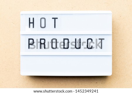 White lightbox with word hot product on wood background