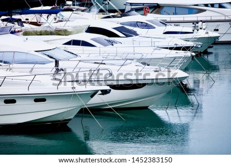 yachts and speed boats at harbor. yachts moored in the port. Ocean Coast pier. High class lifestyle. Yachting. Expensive toys. Sea ​​transport. Journey. Yachting sport. Expensive yachts at the pier. Royalty-Free Stock Photo #1452383150