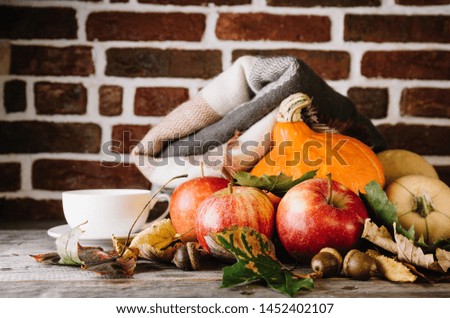 Autumnal arrangement with vegetables and plaid