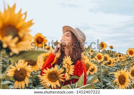 Woman With Hat in a Sunflower Field stock photo