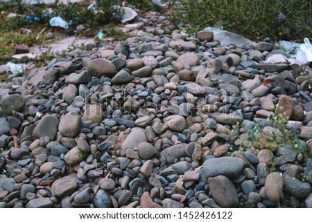 A pile of stones of different colors and sizes. 