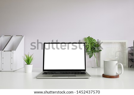 Office desk Workspace stuff with notepad, laptop and coffee cup mouse notepad shot. Royalty-Free Stock Photo #1452437570