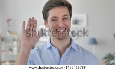 Hello, Handsome Young Man Waving Hand to Welcome