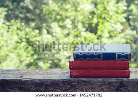 Old books on the garden wooden table 