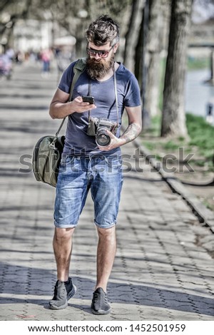 Photographer with beard and mustache. Tourist shooting photos. Content creator. Man bearded hipster photographer. Old but still good. Photographer hold vintage camera. Modern blogger. Manual settings.