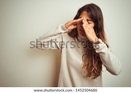 Young beautiful woman wearing winter sweater standing over white isolated background rubbing eyes for fatigue and headache, sleepy and tired expression. Vision problem