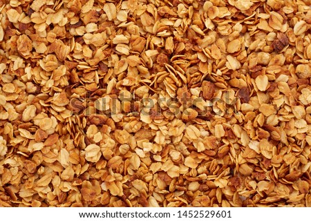 Organic homemade Granola Cereal with oats and almond. Texture oatmeal granola or muesli as background. Food concept. Healthy and wholesome food. Royalty-Free Stock Photo #1452529601