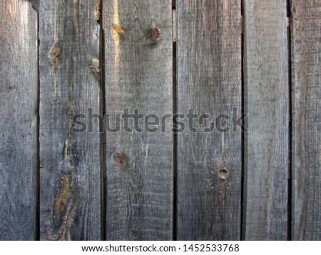 Close-up of aged unpainted peeling old wooden surface, background texture. Wooden background from which the old varnish peeled off, texture.