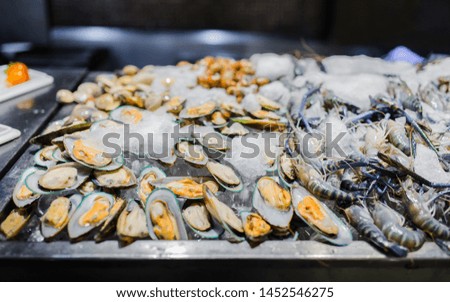 Picture of fresh green mussel and prawns in seafood on ice buffet bar