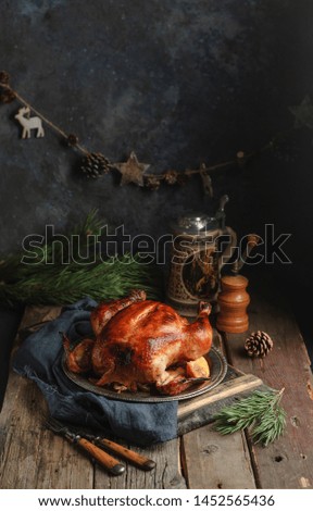 Roasted christmas chicken on a wooden rustic table