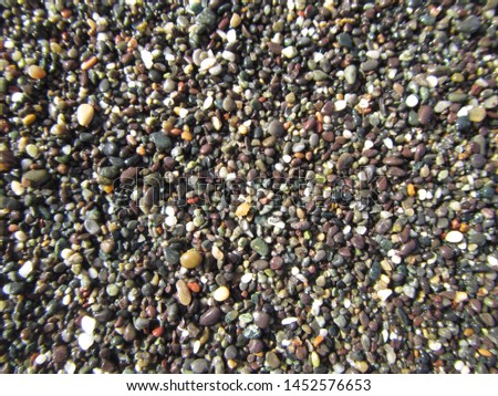 Multi-colored small pebbles on the beach