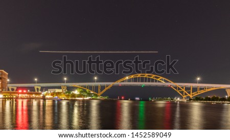 Hoan Bridge in Milwaukee at night with Light Trail from Airplane