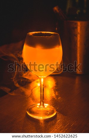 Glass of orange drink in a bar