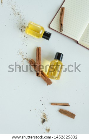 Top view of bottles with cinnamon essential oil. Healthy cosmetic product
