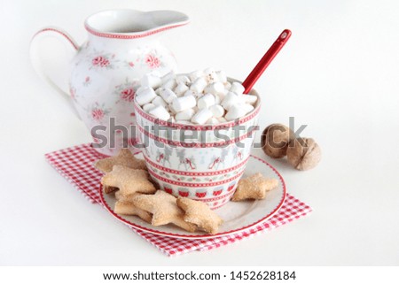 Marshmallow with cocoa in a ceramic Cup with Christmas print and cookie stars on a white background