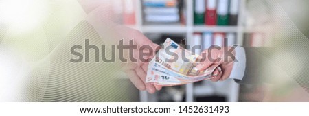 Hands exchanging cash; panoramic banner