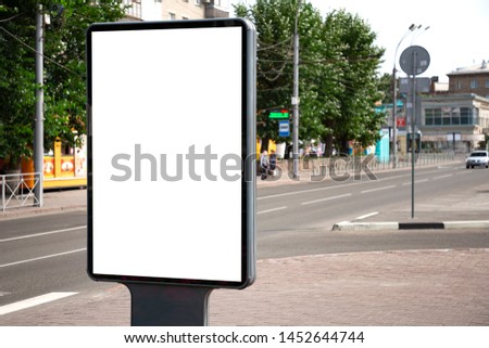 Vertical blank billboard. Mockup of outdoor advertising with copy space on the city street sidewalk.