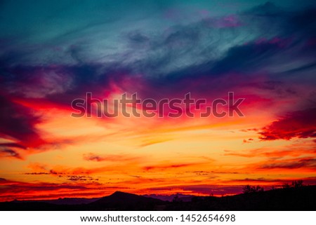 A sunset over the Sonoran Desert of Arizona with high altitude clouds.