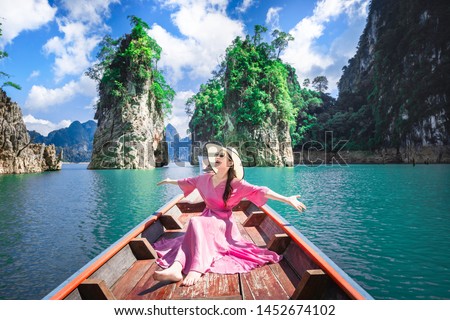 Asian woman posing on boat  in Ratchaprapha dam Khao sok national park at suratthani,Thailand Royalty-Free Stock Photo #1452674102