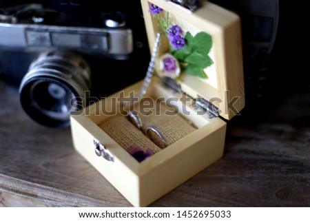 jewelry rings on box with vintage camera.