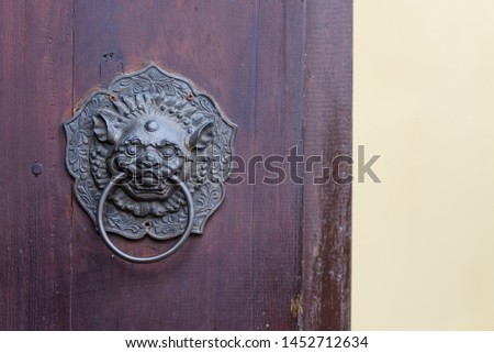 Antique chinese lion handle on wooden door. with copy space