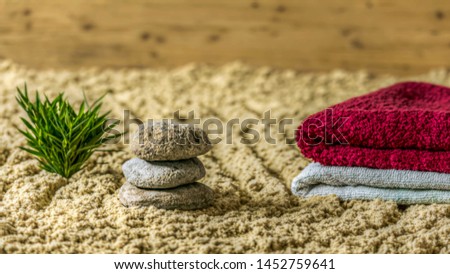 Wellness - towels on sand and stone poplar