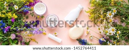 Eco friendly skincare. Natural cosmetics and organic herbs and flowers on pink background, top view, banner. Bio research and healthy lifestyle concept.