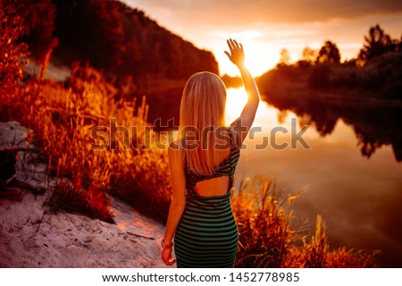 girl welcomes the dawn by the river