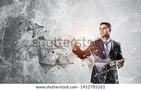 Business person pointing on abstract network structure. Standing personal assistant in business suit and tie on white background. Social connection and networking. Global cloud technology.