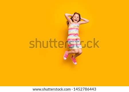 Full length photo of cute astonished child touching her head screaming shouting isolated over yellow background