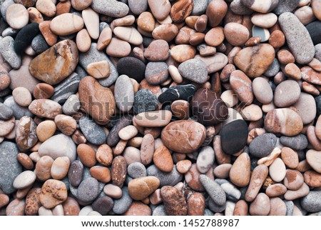 Multicolored colorful sea pebbles, natural background, texture. Close-up texture of colorful sea pebbles. Small Rock. Sea background Royalty-Free Stock Photo #1452788987