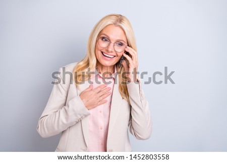 Portrait of her she nice-looking attractive lovely stylish cheerful cheery glad delighted friendly gray-haired lady discussing good news isolated over light white gray background