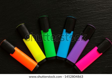 School and office supplies on a black background
