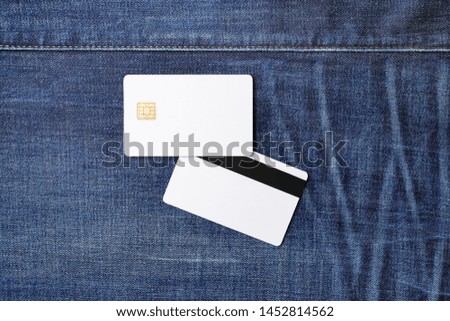 Two blank credit cards on denim background. Chip cards. Mockup for branding identity. Template for graphic designers portfolios. Flat lay.