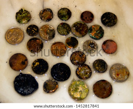 The photo of gold and silver  coins collected with help of underwater metal detector. Treasure searching and tourist adventure background.