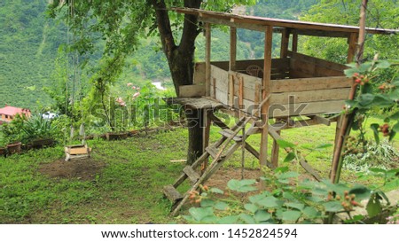 Little low budget kind of tree houseor handmade play house and tree swing