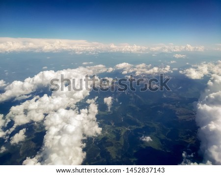 View from the airplane to the sky above the Montenegro mountains. Blue sky with clouds. Background. stock photo