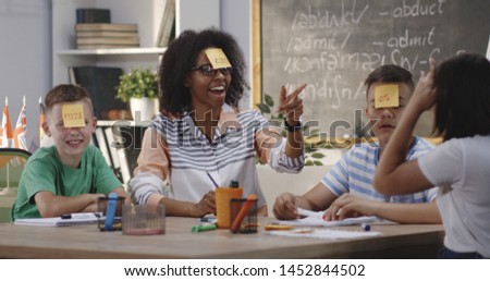 Medium long shot of a teacher and students in a classroom Royalty-Free Stock Photo #1452844502