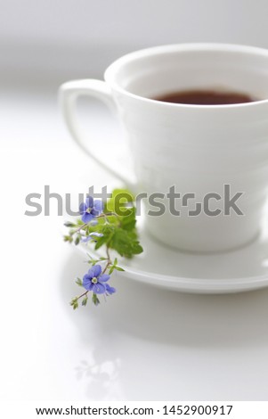 Coffee and flower on white table. Cozy breakfast. Good morning.