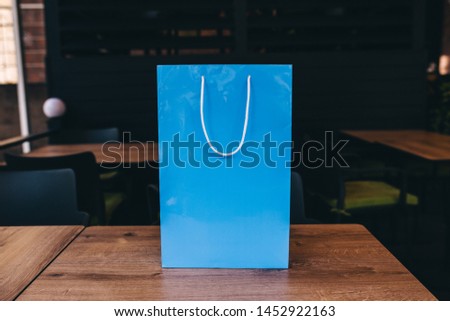 Paper shopping 
colored bag with handles with blank space for your logo or text. Mock-up of blank craft package