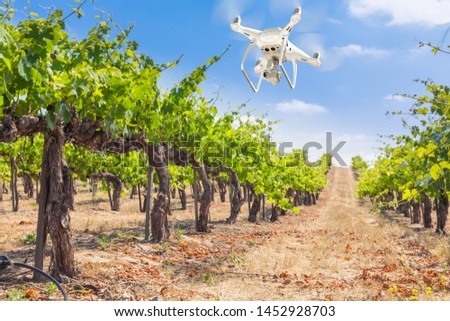 Unmanned Aircraft System (UAV) Quadcopter Drone In The Air Over Grape Vineyard Farm. Royalty-Free Stock Photo #1452928703