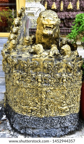 Close-up of Golden Lion statue on the stairs to the temple in Bangkok, Thailand.