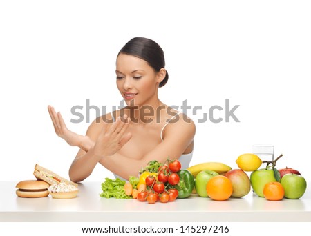 picture of woman with fruits rejecting hamburger